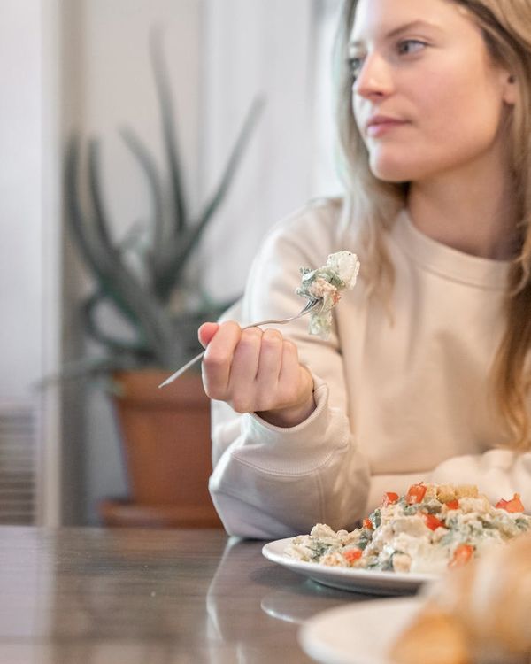 Woman feeling vibrant and balanced in a modern living room.